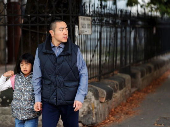 a Chinese immigrant walks his daughter to school in Budapest
