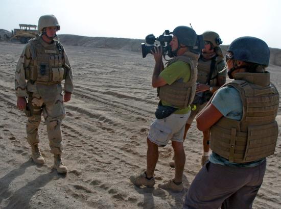 journalist filming a soldier