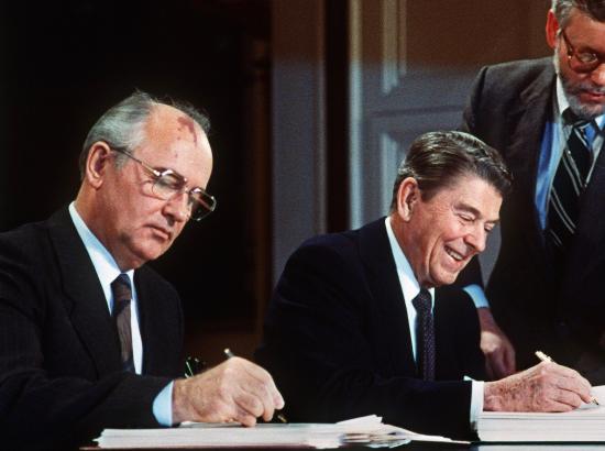 Reagan and Gorbachev signing the INF Treaty in the East Room of the White House, December 1987.
