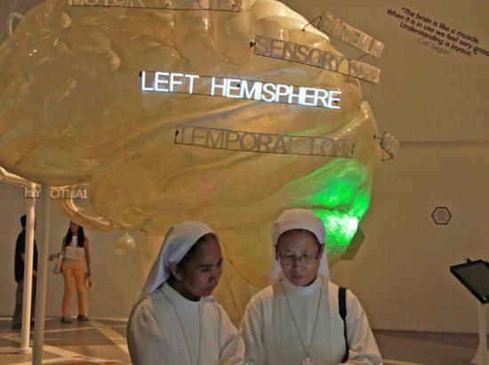 two nuns walk through an exhibit at the Brain Museum in Manila, Philippines