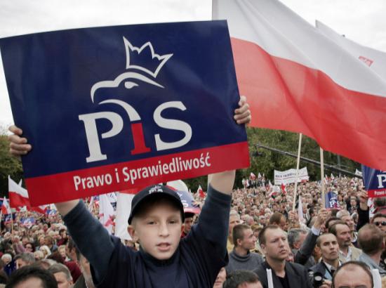 boy holds PiS party placard at demonstration in Poland (image: Wojtek Radwanski, AFP / Getty)