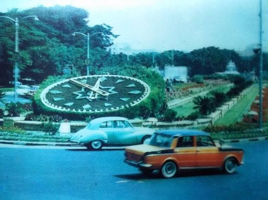 cars drive around flower clock at Sa'at Al Zouhour Square Alexandria, Egypt