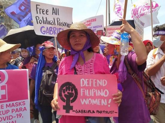 Women protest holding 'Gabriela' placards demanding defense of women's rights in the Philippines