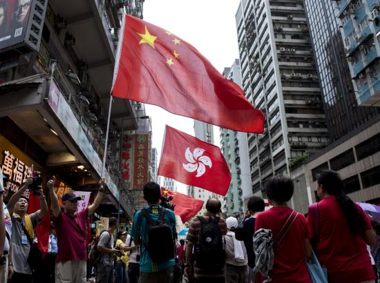 pro-Beijing protestors wave Hong Kong and PRC flags