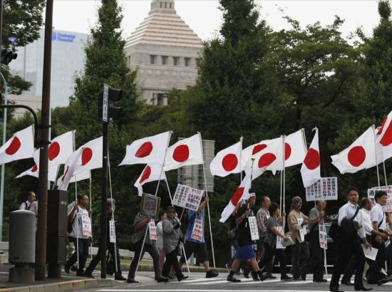 flag-beaering marchers outside the Japanese parliamentary Diet building in Tokyo