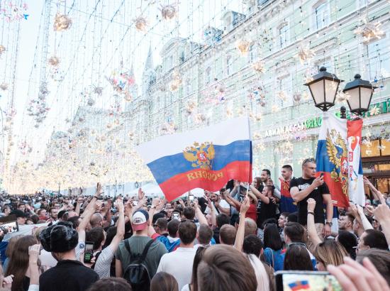 crowds of fans hoist Russian flag in Central Moscow during the 2018 FIFA World Cup