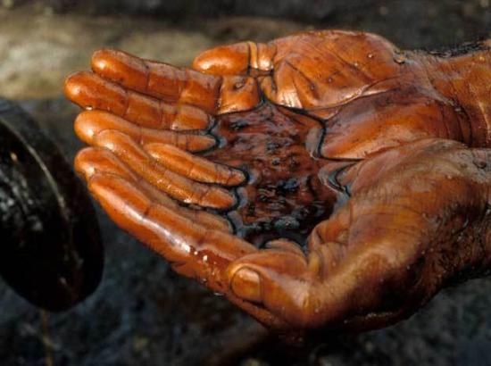 hands cupping crude oil