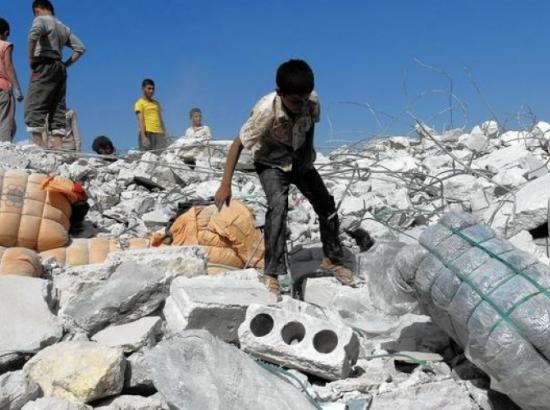 children climbing upon the rubble of U.S.-led coalition airstrike in Kafar Daryan in Syria. (Photo: Getty Images)