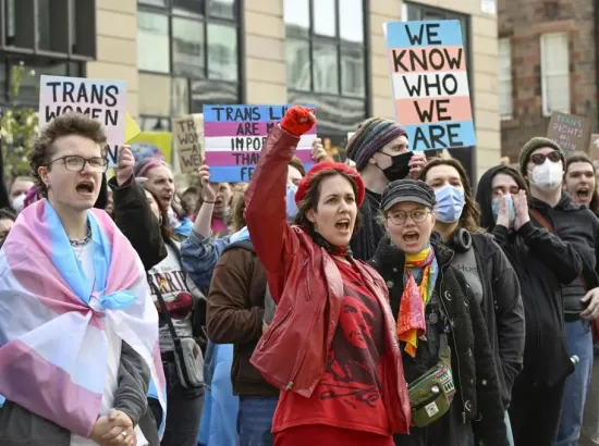 People from trans rights groups and community organizations take part in a rally following the Supreme Court ruling on the definition of a woman in equalities law.   © 2025 Lesley Martin/AP Images
