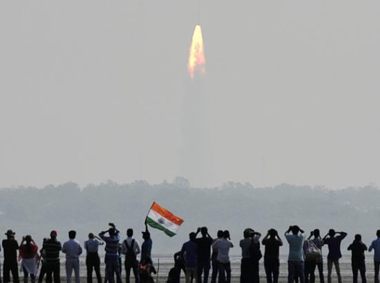 Spectators watch the launch of an Indian Space Research Organisation (ISRO) rocket