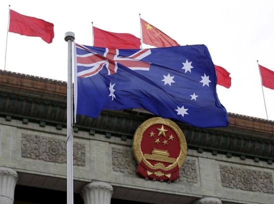 Australian flag waves in front of the Great Hall of the People in Beijing, China