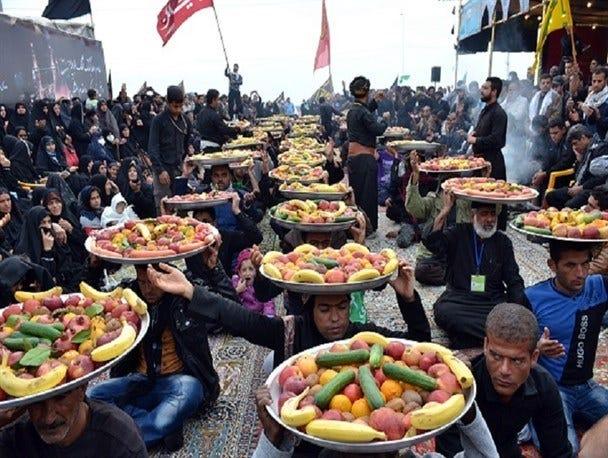 Locals carry food on their heads to welcome the pilgrims