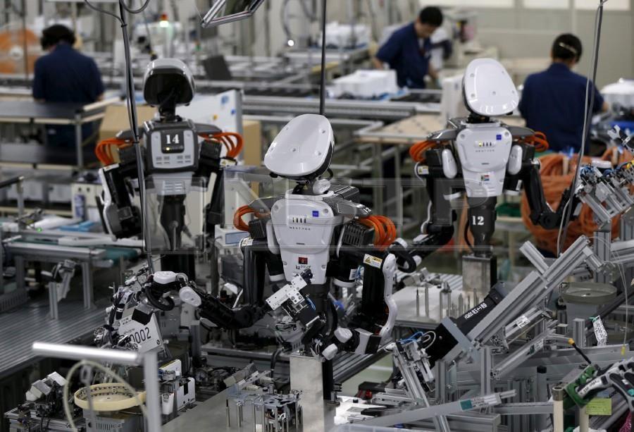 robots on factory floor with human workers