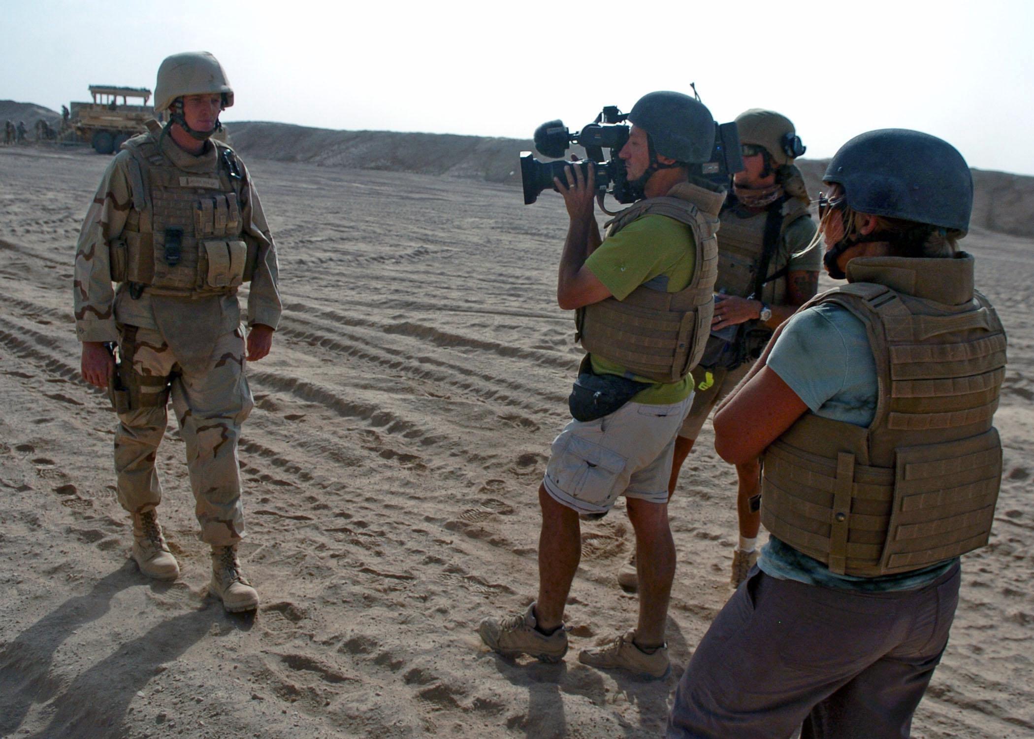 journalist filming a soldier