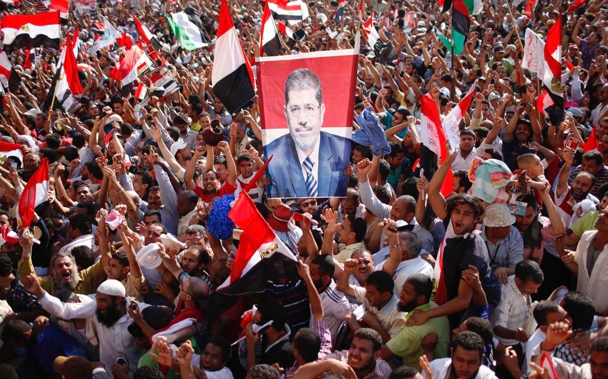 crowd with banner portraits of Muslim Brotherhood candidate Mohamed Morsi