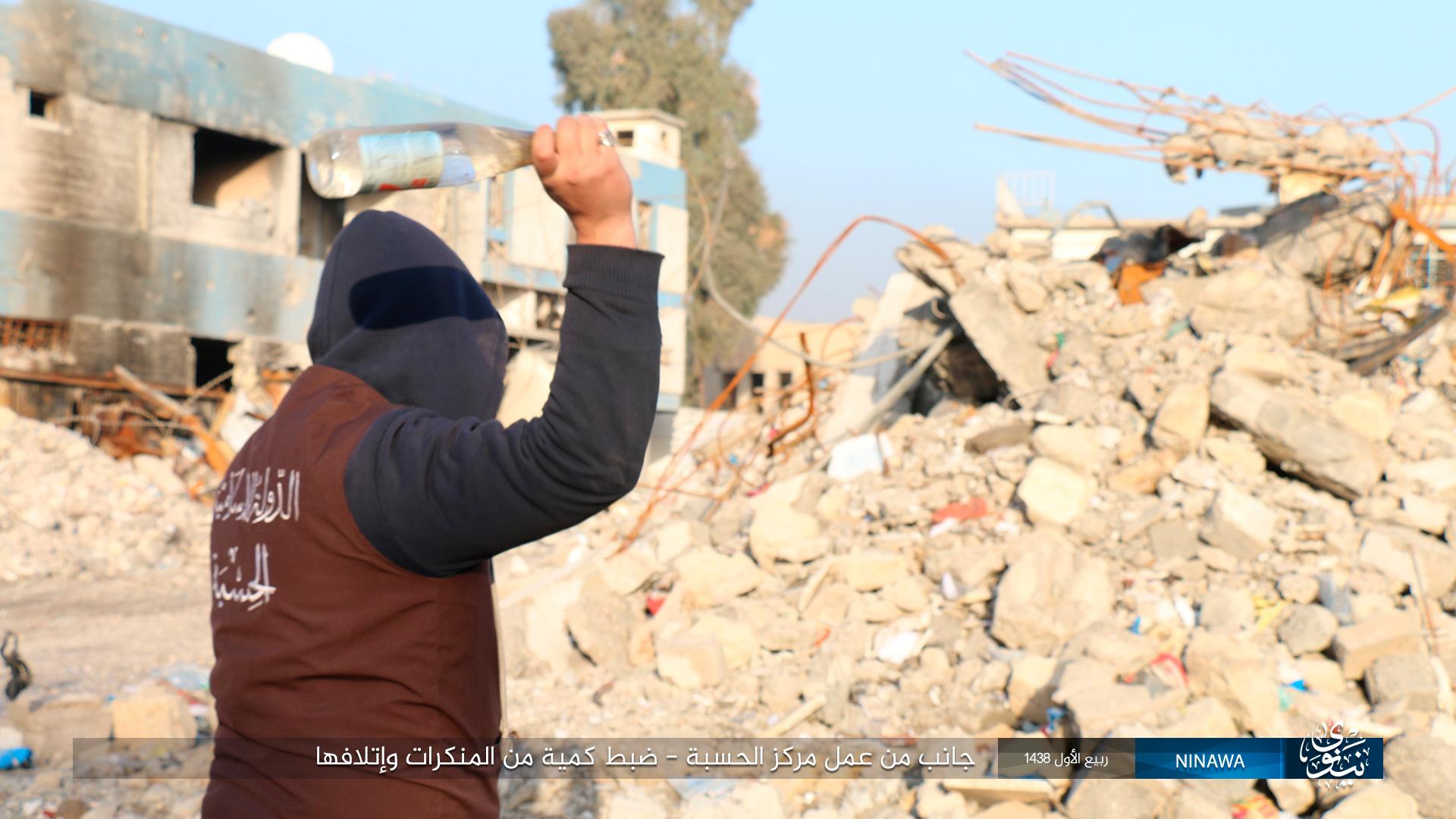 hisba agent destroying a bottle of alcohol