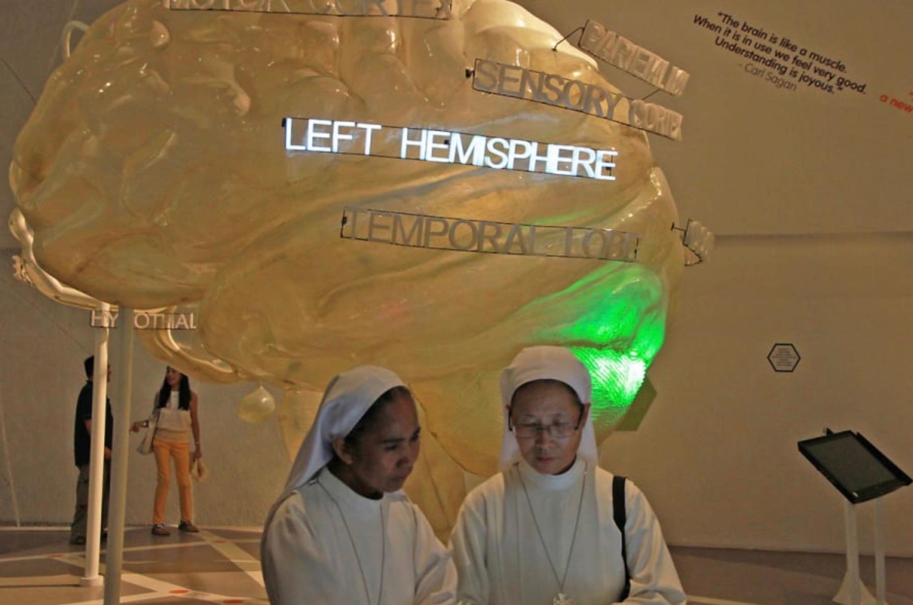 two nuns walk through an exhibit at the Brain Museum in Manila, Philippines