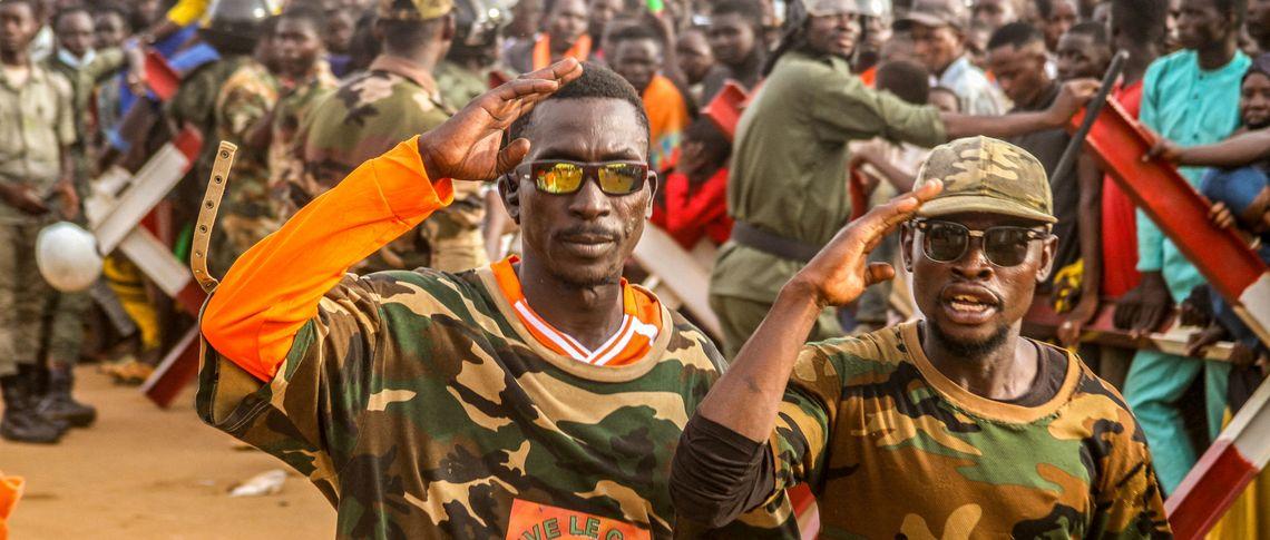 Niger's military-government supporters take part in a demonstration in front of a French army base in the capital Niamey