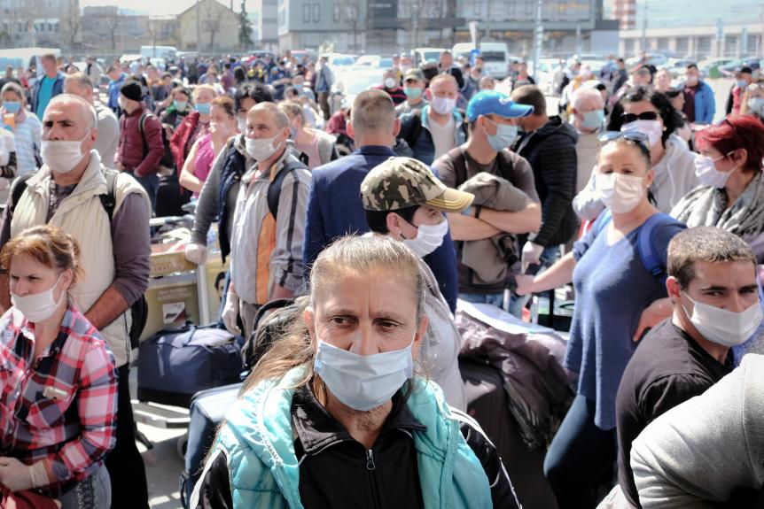 Romanian seasonal workers wait outside the Avram Iancu International Airport in Cluj, central Romania