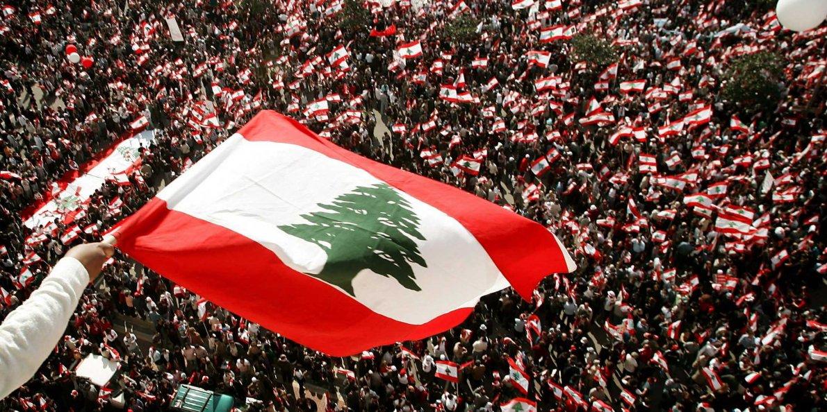 Lebanese flag over thousands of anti-Syrian protesters during a rally in Beirut on March 14, 2005