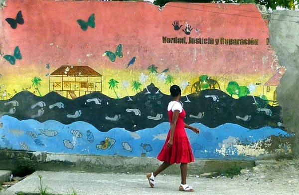 Girl walking in front of a mural