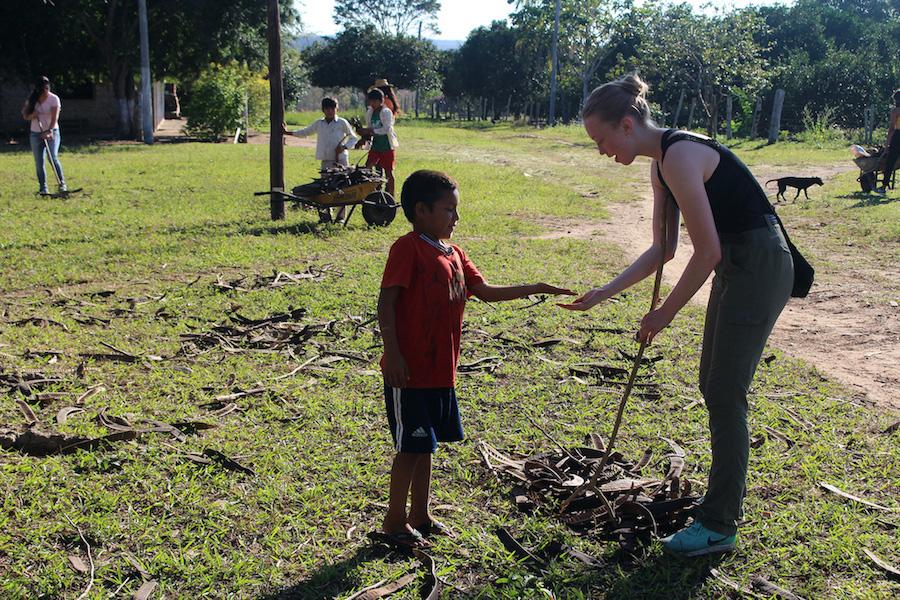 American studen engages with villiage children on a program in Bolivia