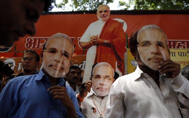 Indian voters at 2014 rally wear masks of the face of Narendra Modi