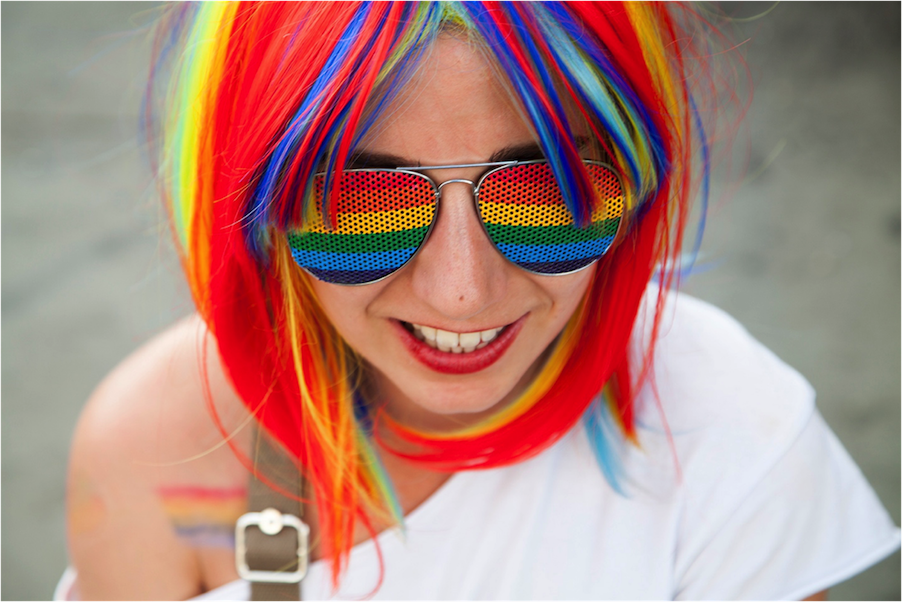 woman with rainbow hair and sunglasses at London Pride event, July 7, 2018