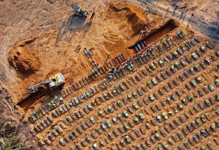 coffins being buried at Parque Tarumã cemetery in Manaus, Brazil