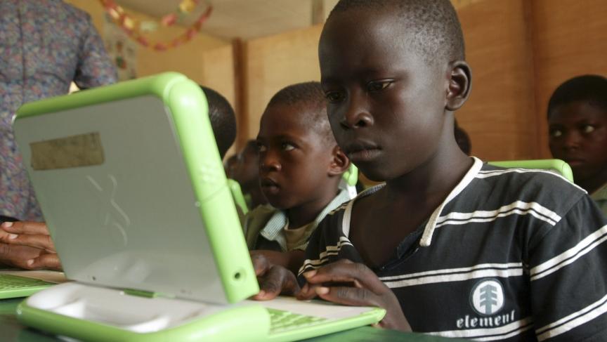 Nigerian children work on computers provided by One Laptop Per Child project