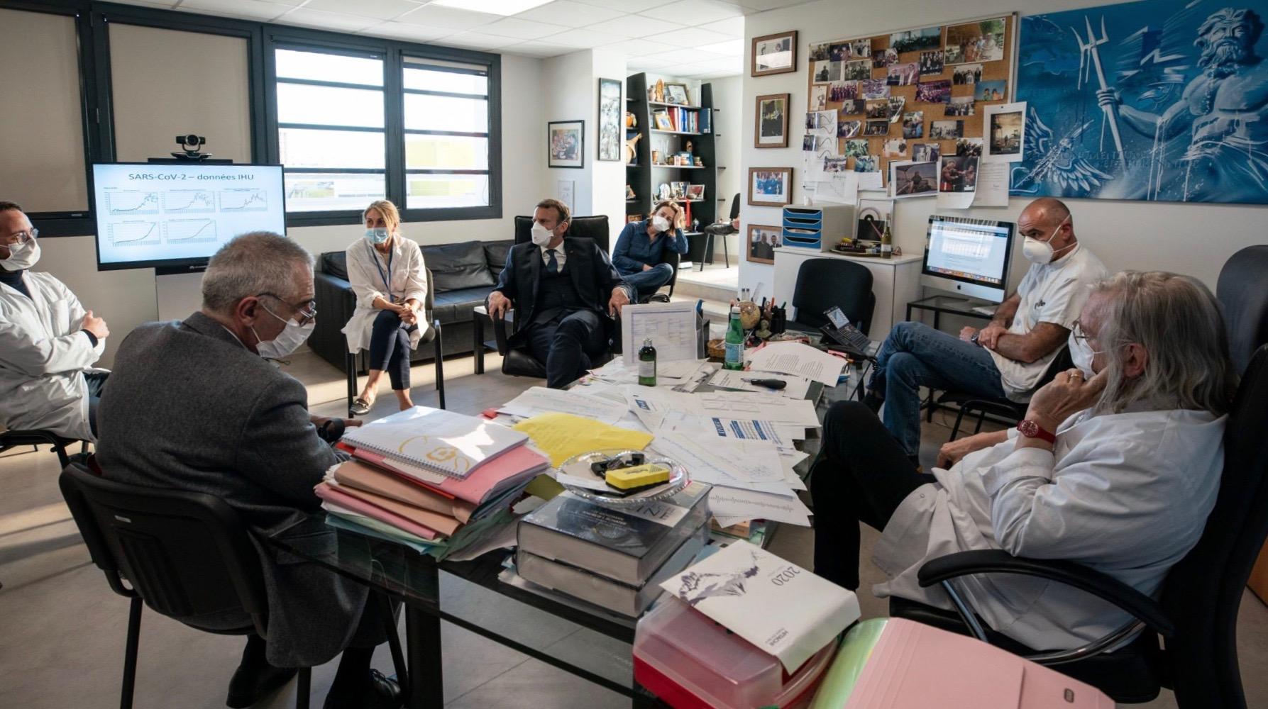 French president Emmanuel Macron (center) meets with health experts in the office of Dr. Didier Raoult