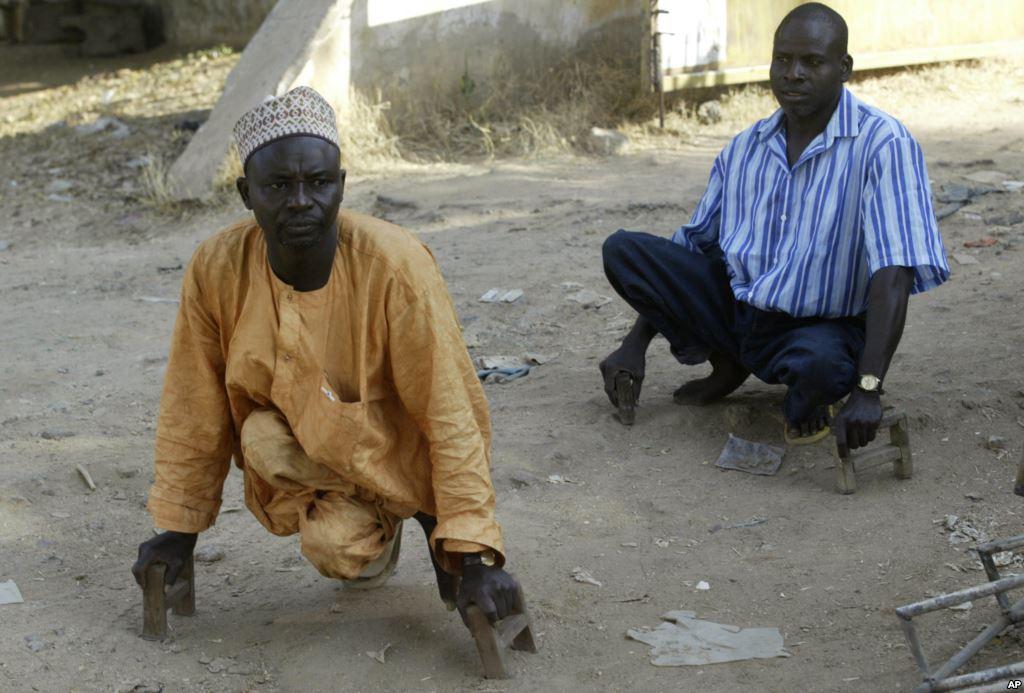 two men using wood canes move around