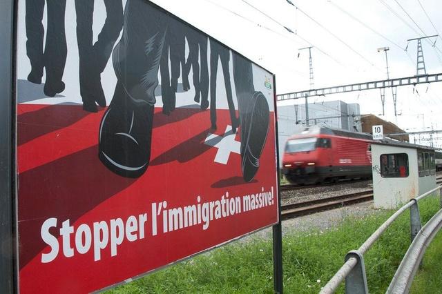 anti-immigration poster near train station in Switzerland