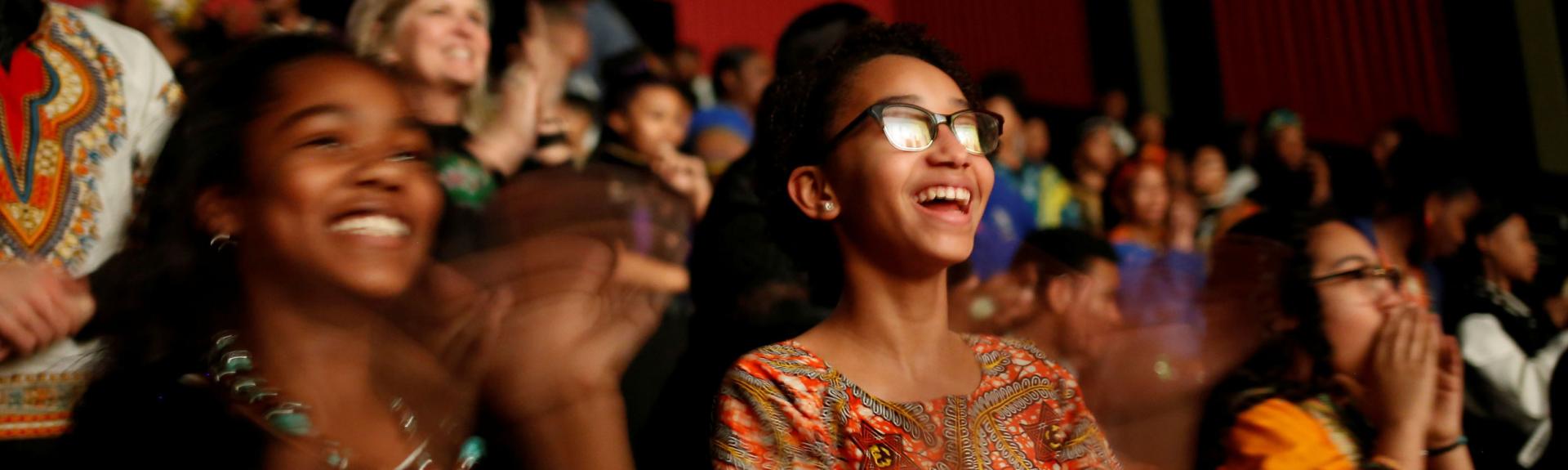 Audience clapping in excitement during Black Panther screening