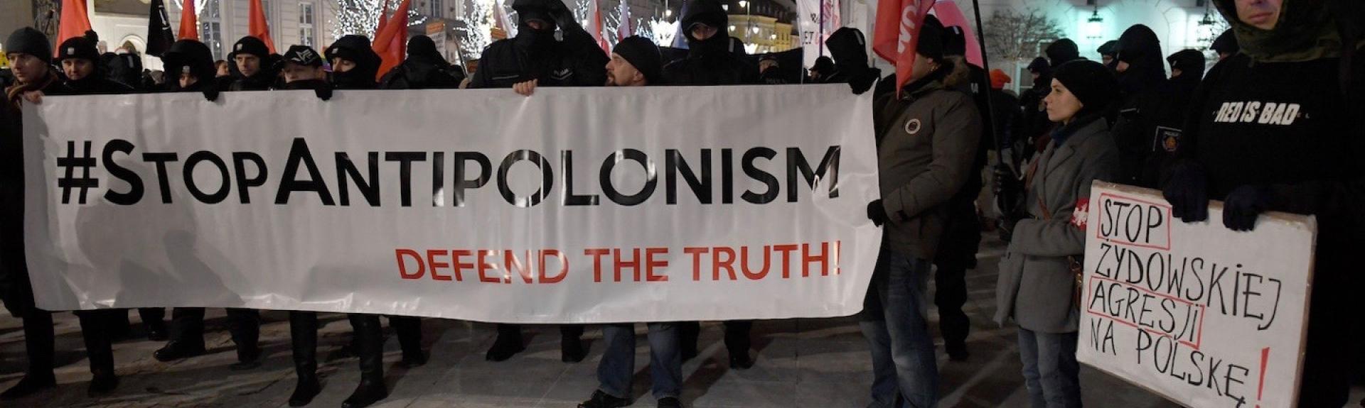 protestors in Warsaw hold banner that reads 'Stop Anti-Polonism'