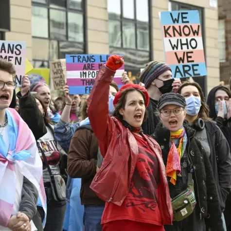 People from trans rights groups and community organizations take part in a rally following the Supreme Court ruling on the definition of a woman in equalities law.   © 2025 Lesley Martin/AP Images