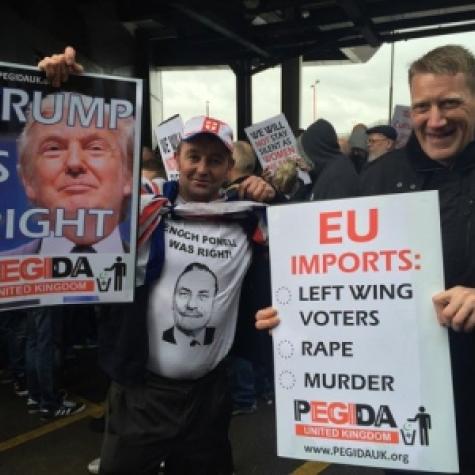 protestors hold anti-immigration banners at PEGIDA rally in the UK