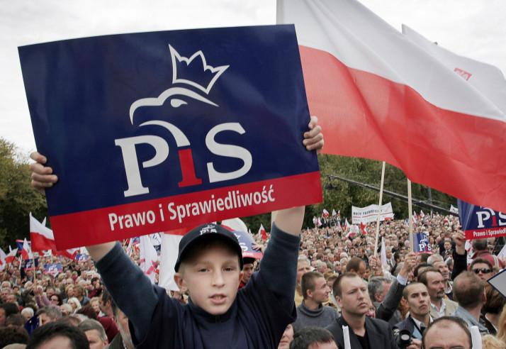 boy holds up PiS party placard - image credit Wojtek Radwansk-AFP-Getty
