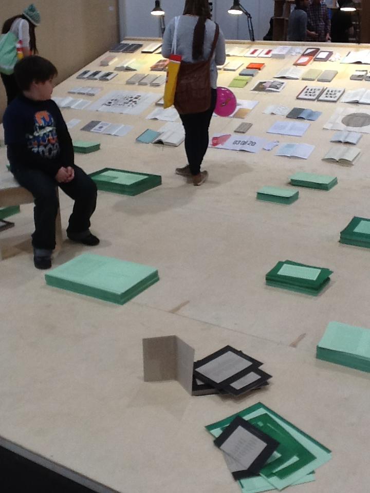 book exhibition being installed as a boy looks on