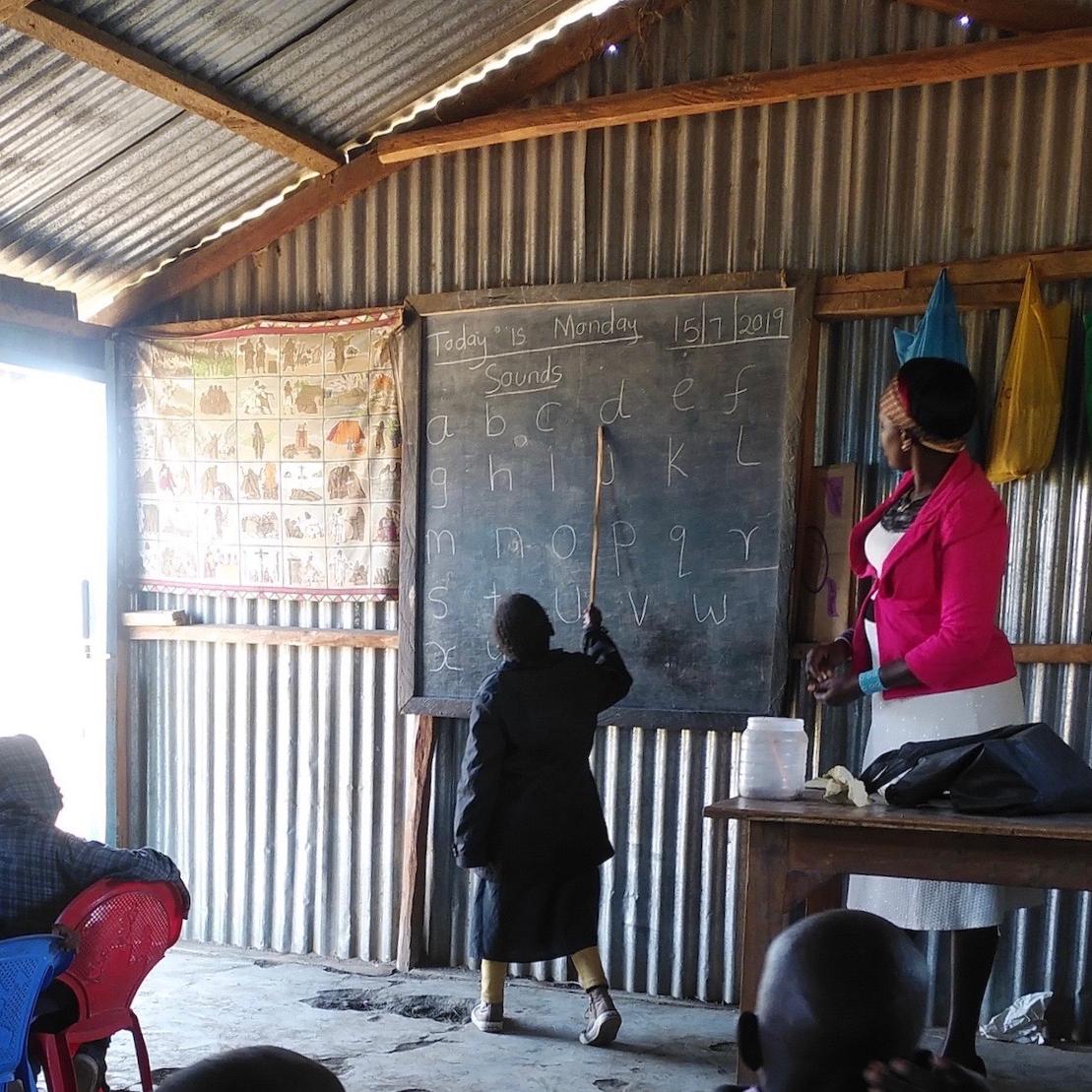 Child learning the alphabet at the blackboard