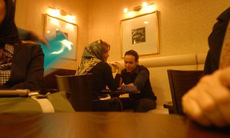 Couple sitting on the floor in dimmed room