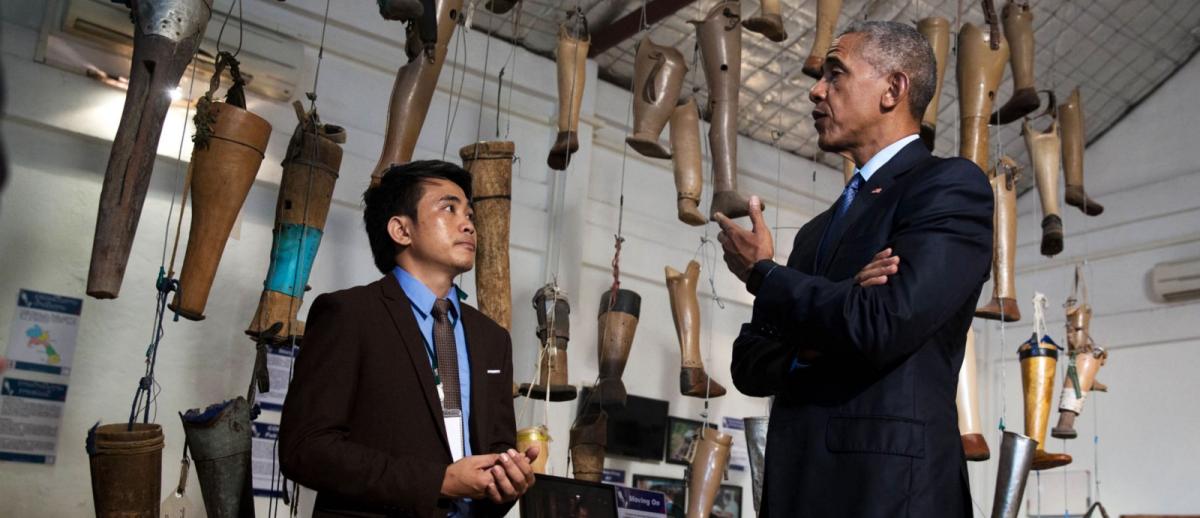 U.S. President Barak Obama discusses cluster bomb victims with Soksai Sengvongkham, operations manager of the Cooperative Orthotic and Prosthetic Enterprise (COPE) visitors' centre in Vientiane, September 2016.