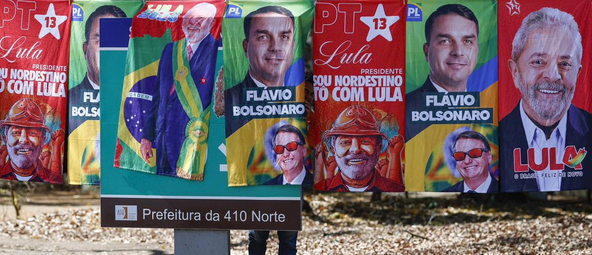 Towels and caps for sale in a residential area of Brasília depict Brazilian presidential candidates Luiz Inácio Lula da Silva and Flávio Bolsonaro, on September 11, 2026. Sergio Lima/AFP/Getty Images