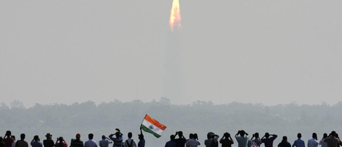 Spectators watch the launch of an Indian Space Research Organisation (ISRO) rocket