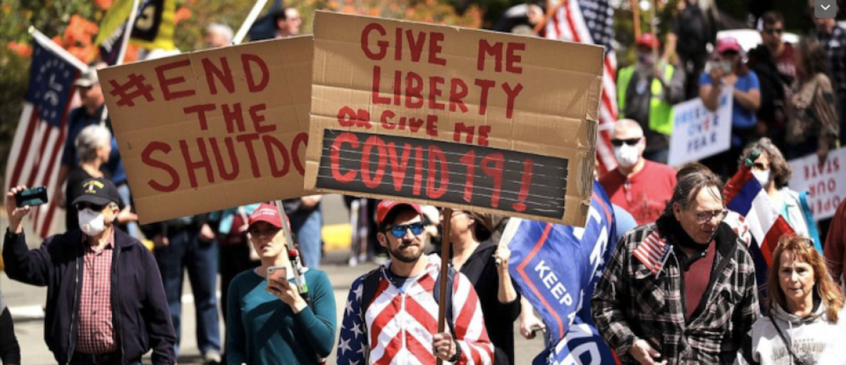 protestors with US flags and signs demanding an end to corona pandemic state shutdowns