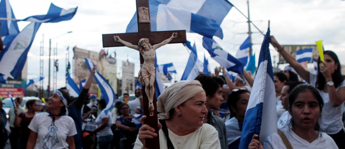 demonstrator holds a crucifix during a protest against Nicaraguan President Daniel Ortega's government in Managua, Nicaragua