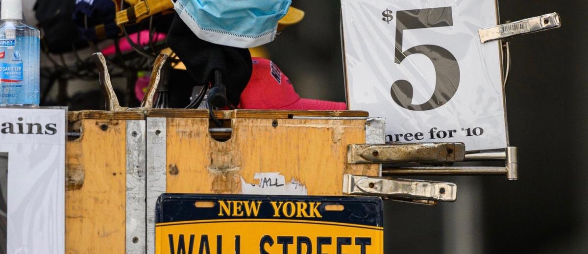 a New York street vendor cart advertising masks for $5.00, beneath it a New York license plate reading 'Wall Street'