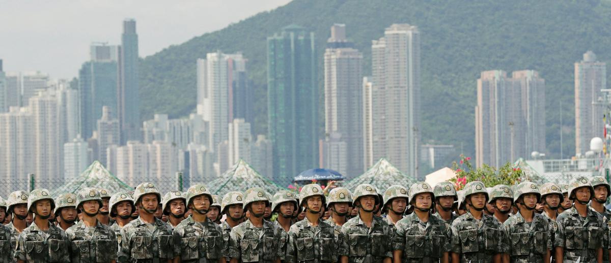 Hong Kong skyline behind People’s Liberation Army soldiers at Stonecutters Island naval base in Hong Kong, June 2019