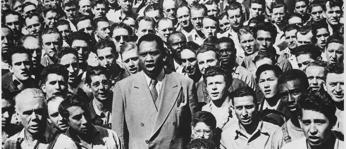 Paul Robeson sings among a crowd of workers