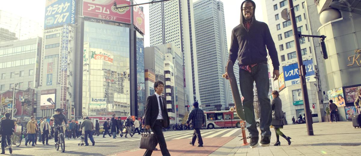 skateboard man flying, major pedestrian street crossing Tokyo, Japan. Image copyright Natxo Bassols.